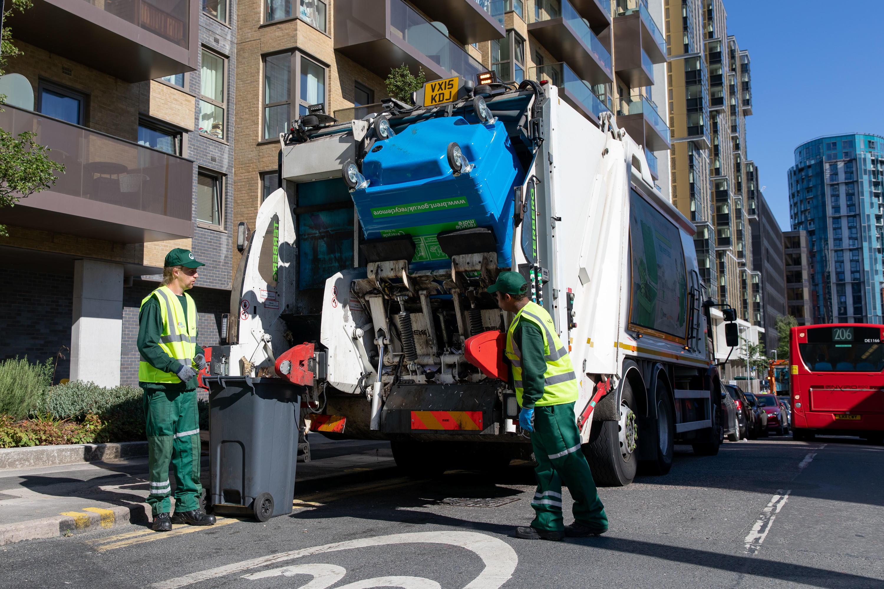 Veolia operatives load bins on to the back of the truck.